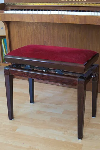 piano bench: a rectangular wooden bench where a pianist can sit while playing the piano