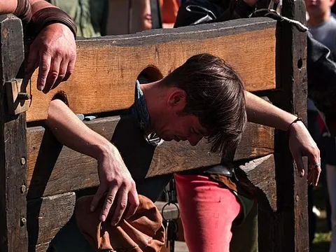 pillory: a framework on a post, with holes for the hands and head, used as a means of punishment and...