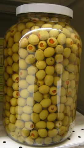 pimola: an olive stuffed with a kind of sweet red pepper, or pimiento