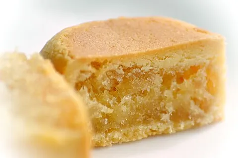 pineapple cake: a small, sweet, crumbly cake containing butter, flour, egg, sugar, and pineapple jam, originating...