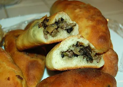 pirozhki: small pastries filled with finely chopped meat, vegetables or fruit baked or fried, from eastern...