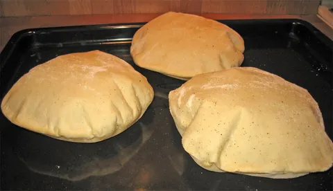 pita: a piece of pita bread; a flatbread pouch used for making sandwiches such as gyros or falafels