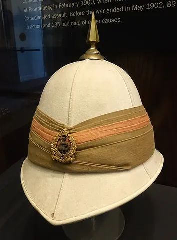 pith helmet: a lightweight helmet-shaped hat made of the pith of the sola or shola (Indian spongewood) plant...