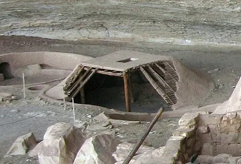 pithouse: a primitive building partially dug into the ground and roofed over