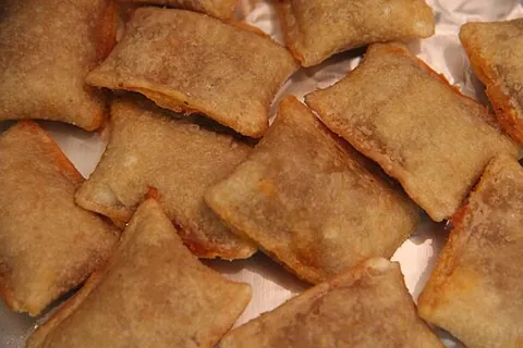 pizza roll: a frozen food, a bite-sized breaded pizza pocket filled with tomato sauce, cheese, etc