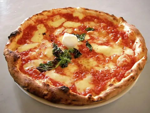 pizza: a baked Italian dish of a thinly rolled bread crust typically topped before baking with tomato...