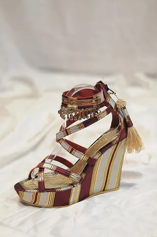 platform shoe: a type of footwear with very thick soles and heels designed to make the wearer appear taller