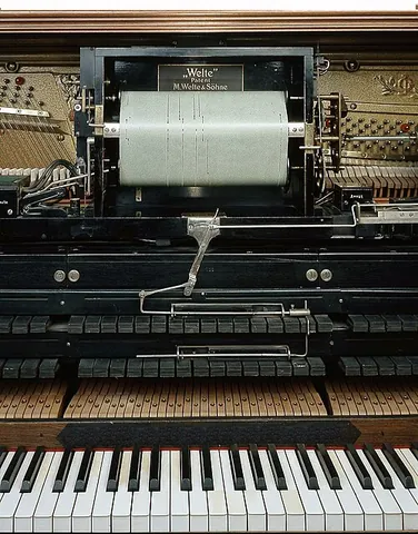 player piano: an acoustic piano that is played automatically by mechanical means