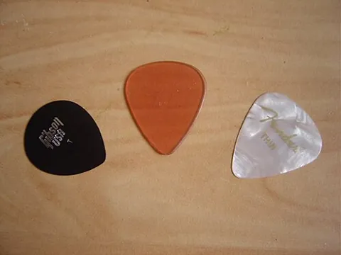 plectrum: a small piece of plastic, metal, ivory, etc., for plucking the strings of a guitar, lyre, mandolin,...