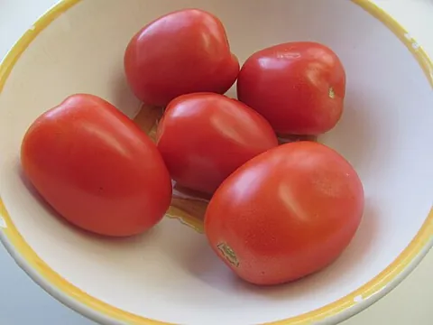 plum tomato: a type of large tomato bred for processing into paste, generally oval or cylindrical in shape, with...