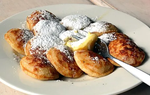 poffertje: a traditional Dutch treat resembling a fluffy pancake, made with yeast and buckwheat flour