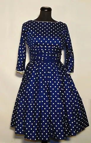 polka dot: any of a number of uniform round dots, repeated to make a regular geometric pattern on a fabric