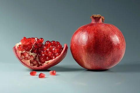 pomegranate: the fruit of the Punica granatum, about the size of an orange with a thick, hard, reddish skin...