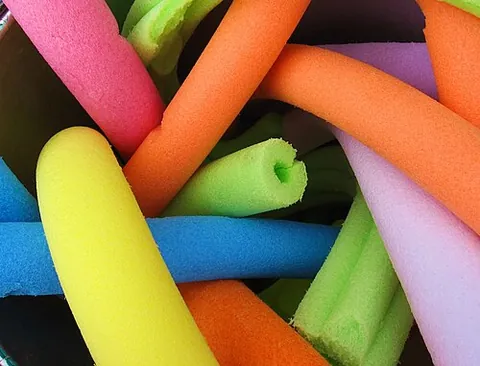 pool noodle: a long, slender tube or rod, extruded from buoyant foam and usually brightly coloured, used as an...