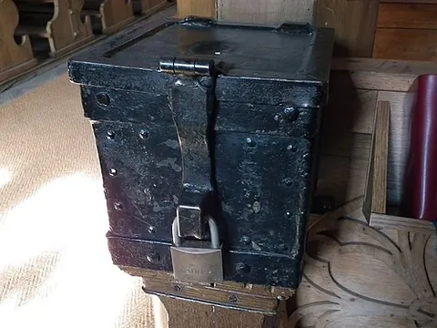 poor box: a locked box with a slot for depositing coins, usually placed in churches to accept donations for...