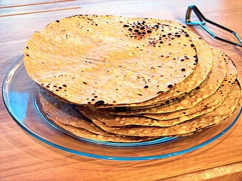 poppadom: a thin, crisp Indian food made from lentil flour, optionally spiced or flavoured in various ways...