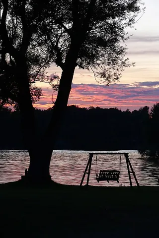 porch swing: a type of swing, often made of wood and having space for two people to sit and rock back and forth....