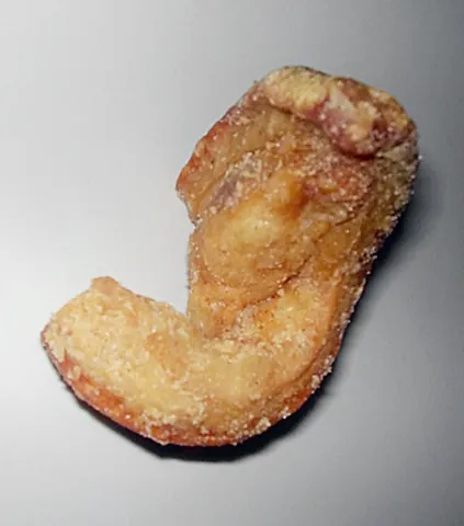 pork scratching: a snack food, normally available in pubs, made from cured pork skin that has been salted and...