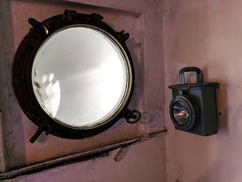 porthole: a circular window set in the hull of a ship