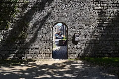 postern: a back door or gate, side entrance, or other entrance distinct from the main one, especially one...