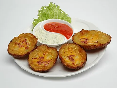 potato skins: a snack food or appetizer made of slices of half-spherical pieces of potatoes with the skin left on...