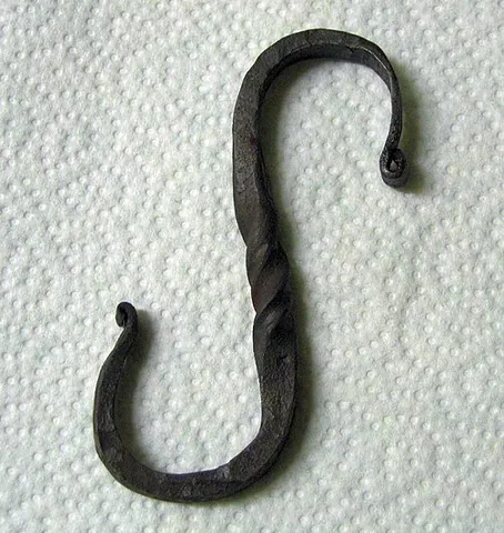 pothook: an S-shaped iron hook used to suspend a cooking pot over a fire