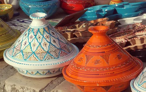 pottery: fired ceramic wares that contain clay when formed