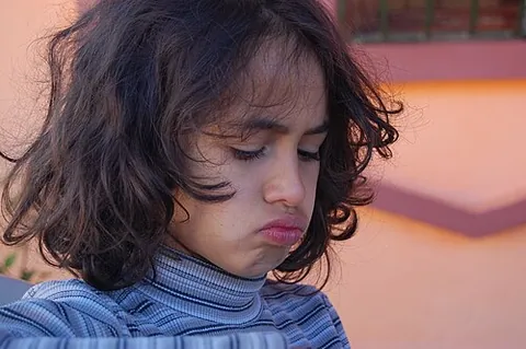 pout: to push out one's lips; especially, to do so in a gesture of dismay, either serious or playful