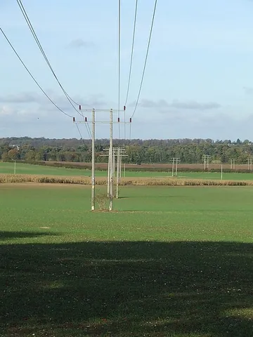power line: an electrical wire, cable or conduit, suspended in air by utility poles or transmission towers, or...