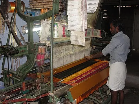 power loom: a mechanized loom powered by a line shaft