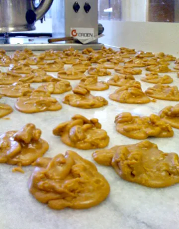 praline: a confection made from almonds and other nuts, caramelized sugar, and sometimes milk or cream