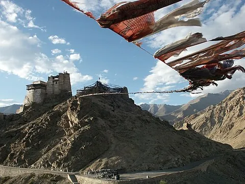 prayer flag: a colourful rectangular cloth hung from a thread and strung along mountain ridges and peaks high in...