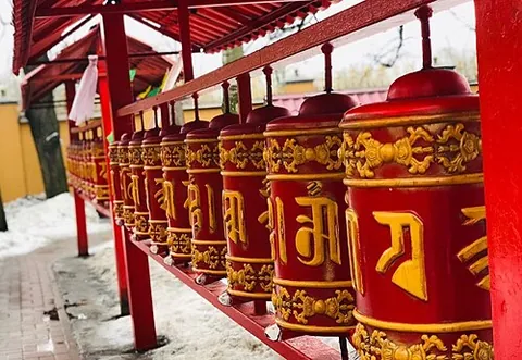 prayer wheel: a rotating cylinder either inscribed with or containing prayers, mainly used by Tibetan Buddhists