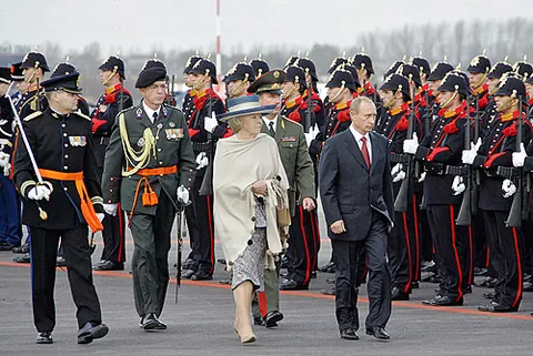 present arms: a position of salute in the manual of arms in which the gun is held in both hands vertically in...