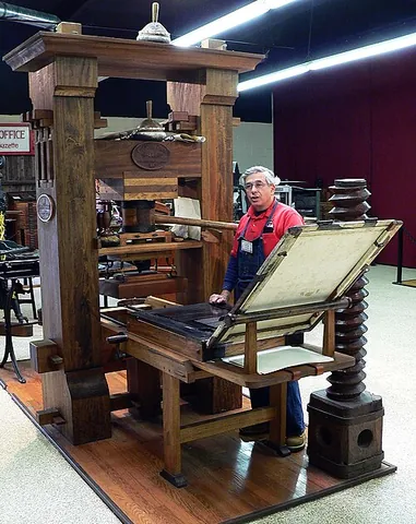 printing press: a mechanical device used for printing text or images repeatedly