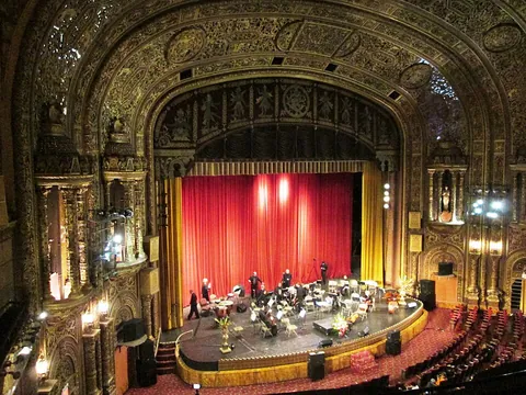 proscenium: the stage area between the curtain and the orchestra