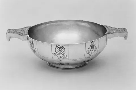 quaich: a traditional shallow, two-handled cup of Scottish origin symbolizing friendship, originally used...