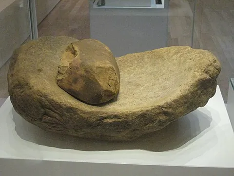 quern: a mill for grinding corn, especially a handmill made of two circular stones