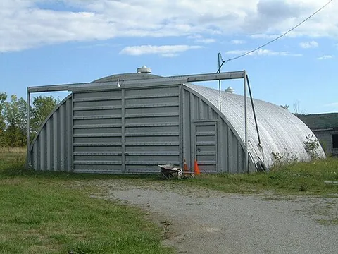 quonset hut: a lightweight prefabricated structure of corrugated galvanized steel, having a semicircular cross...