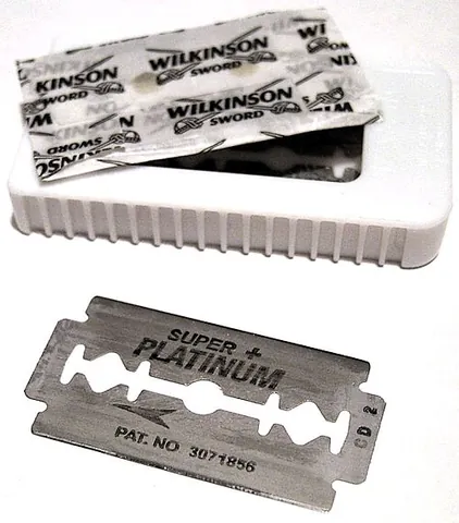 razor blade: a thin piece of steel with a sharp edge that can be fitted into a razor