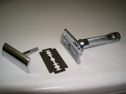 razor: a keen-edged knife of peculiar shape, used in shaving the hair from the face or other parts of the...