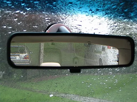 rear-view mirror: a mirror inside a vehicle that allows the driver to see the traffic behind