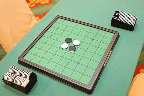 reversi: a strategy game for two players, areas of the board being captured by surrounding rows of the...