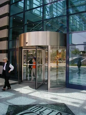 revolving door: a door that rotates around a central pivot
