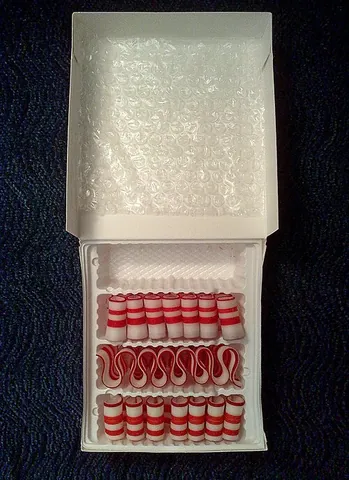 ribbon candy: a type of hard candy, popular around Christmas time, made from flat strips to give a ribbon-like...