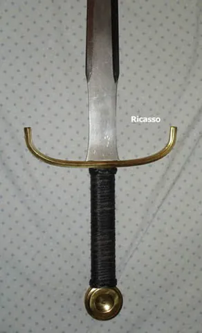 ricasso: the base of a sword or knife blade where it joins the tang