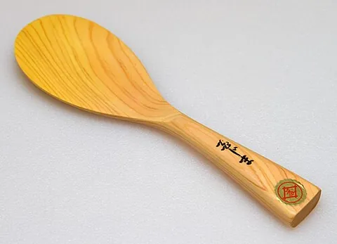 rice paddle: a kitchen utensil used to stir and serve rice