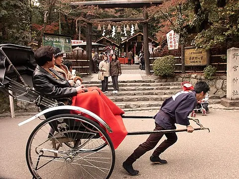 rickshaw: a two-wheeled carriage pulled along by a person