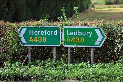 road sign: a sign for the control of traffic or the information of drivers