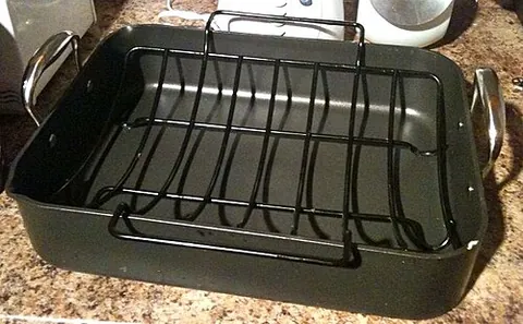 roasting pan: a kitchen utensil used for roasting in an oven